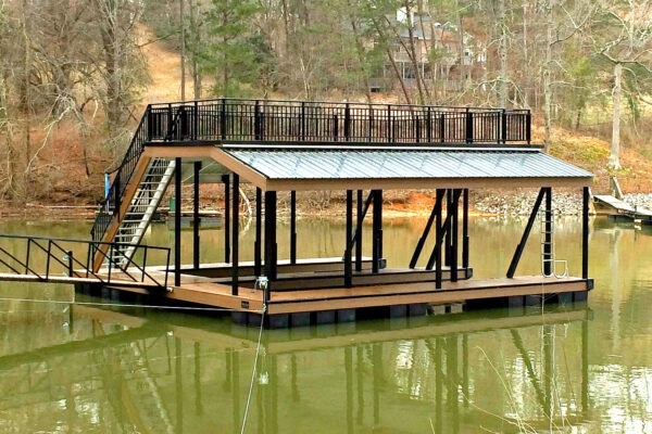 A waterfront dock with a protective roof, accommodating two boats neatly parked.