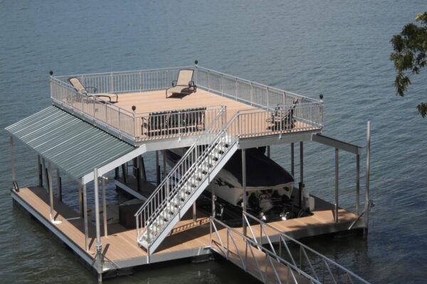 A peaceful waterfront setting with a dock featuring a protective roof and a single boat parked beneath.