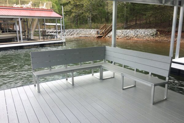 A dock featuring a bench for sitting, overlooking serene waters.