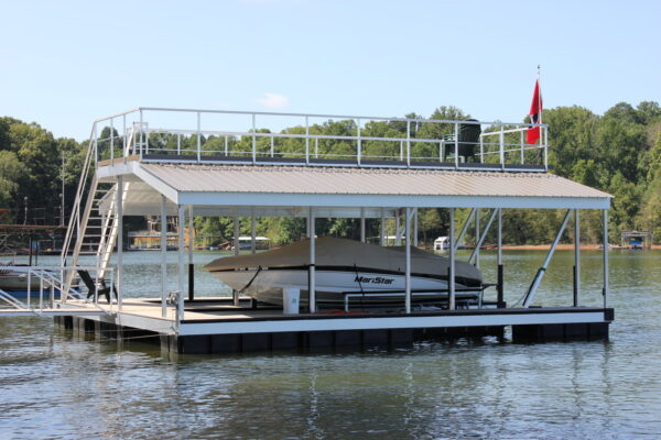 A luxurious waterfront structure designed for a single mega boat, featuring a rooftop with chairs