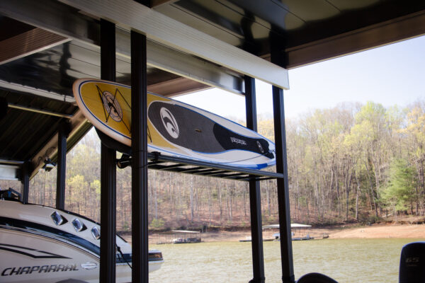 A dock with a stand-up paddleboard resting on its surface, ready for use.