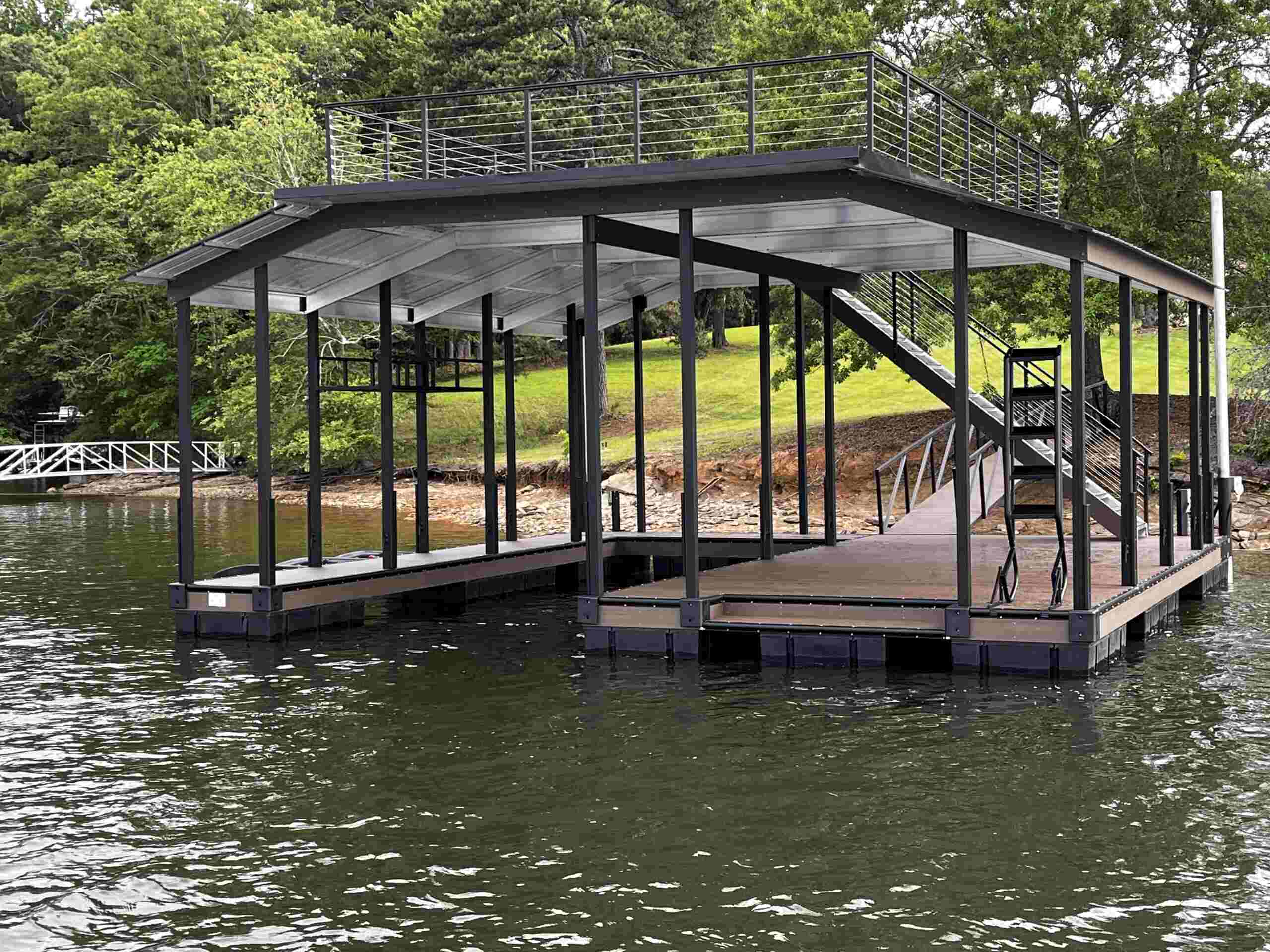 A luxury dock with a single boat berth and a serene seating area overlooking a lush, grassy lawn