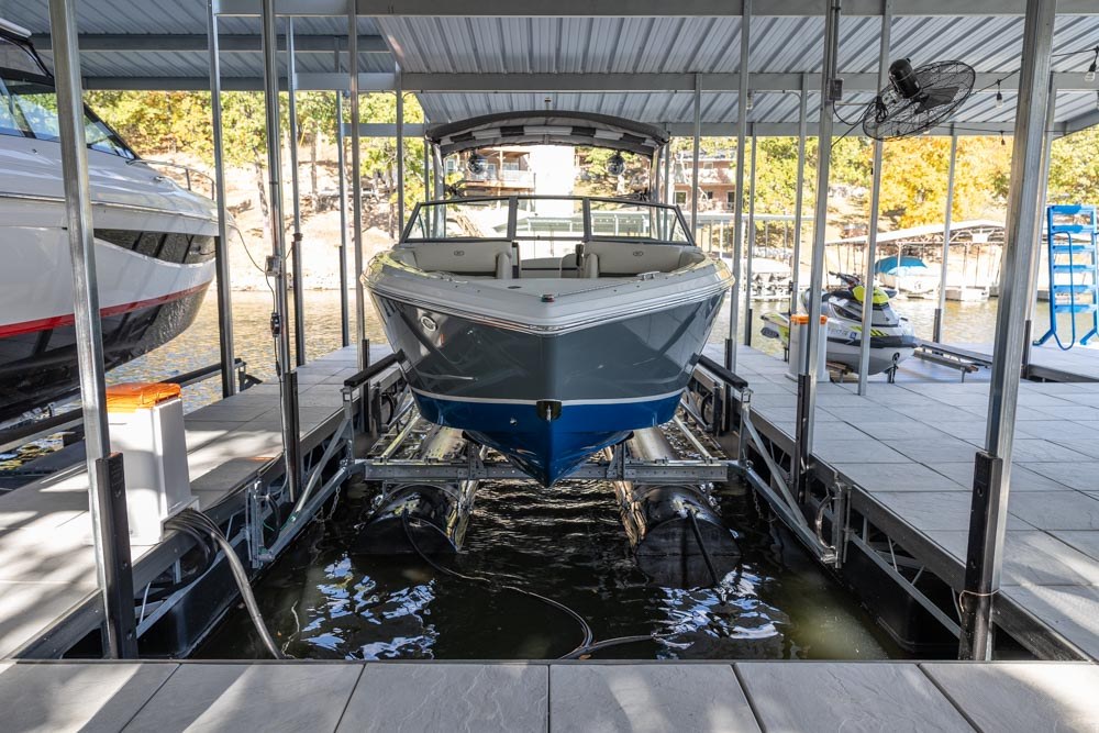 Safely unloading two motor boats at a secure dock facility