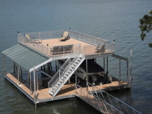 A two-story dock with two boat berths, featuring a second-floor seating area adorned with swim chairs