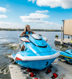 A teenage girl skillfully parking a motor boat in the Wave Armour port.