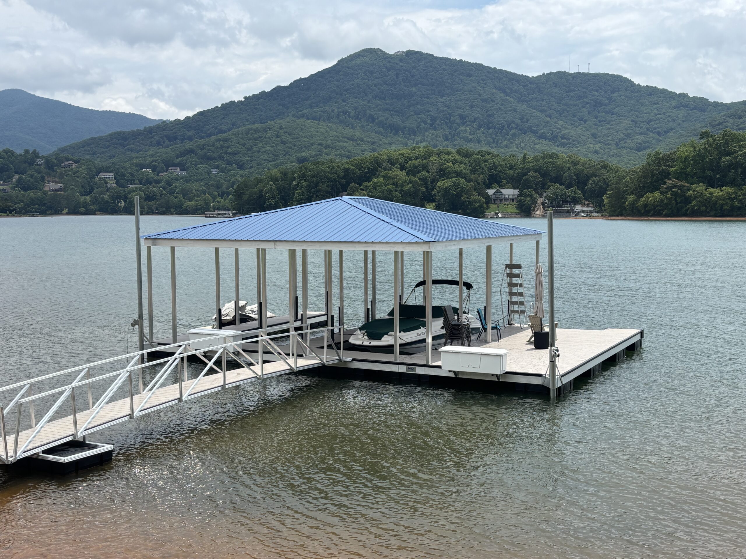 Custom hip roof boat dock with black powder-coated railings built by Martin Docks